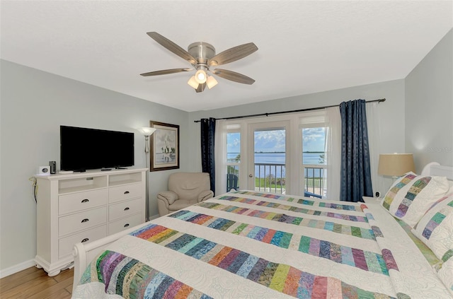 bedroom with light wood-type flooring, ceiling fan, and access to outside