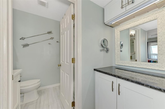 bathroom featuring vanity and toilet