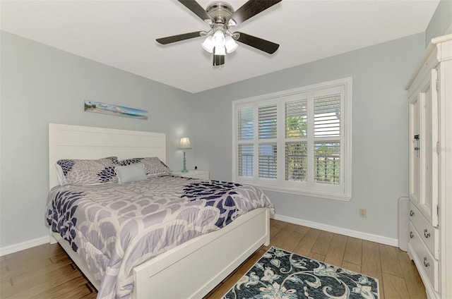 bedroom with ceiling fan and hardwood / wood-style floors