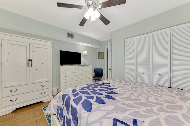 bedroom featuring light hardwood / wood-style flooring, a closet, and ceiling fan