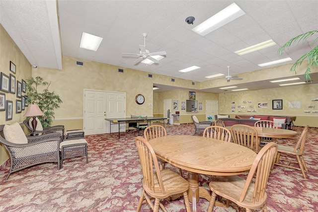 dining area featuring ceiling fan and light colored carpet