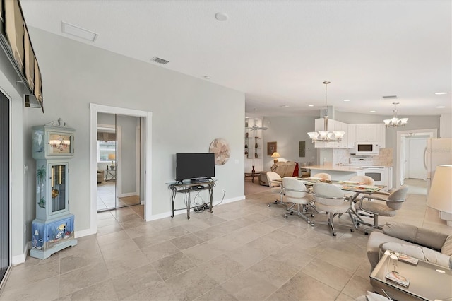 living room featuring a notable chandelier and light tile patterned floors