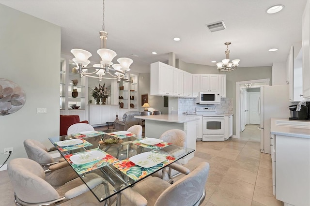 dining room with light tile patterned flooring and an inviting chandelier