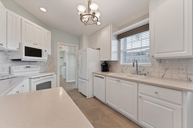 kitchen featuring white appliances, sink, white cabinetry, decorative light fixtures, and decorative backsplash