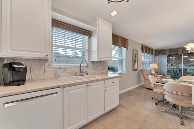 kitchen featuring sink, dishwasher, white cabinets, and tasteful backsplash