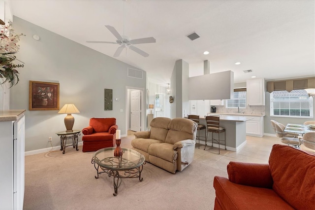 tiled living room featuring ceiling fan and lofted ceiling