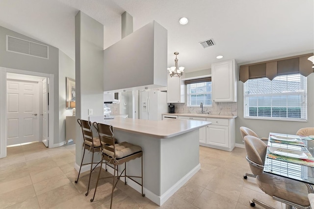 kitchen with white refrigerator with ice dispenser, white cabinetry, hanging light fixtures, and backsplash