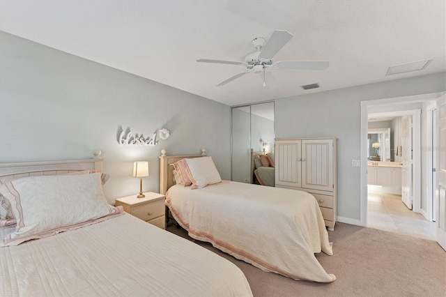 bedroom with a closet, light colored carpet, and ceiling fan