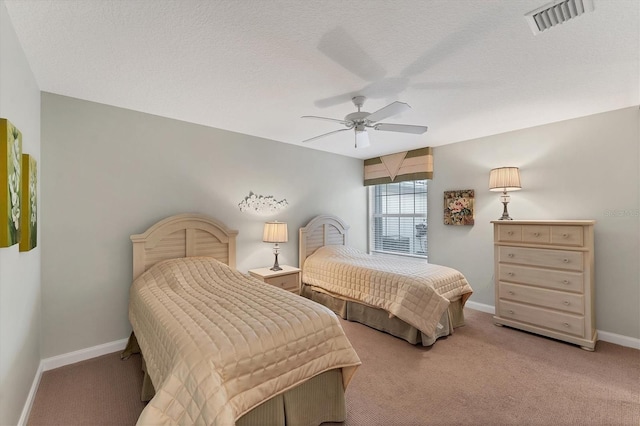 bedroom featuring light carpet, a textured ceiling, and ceiling fan