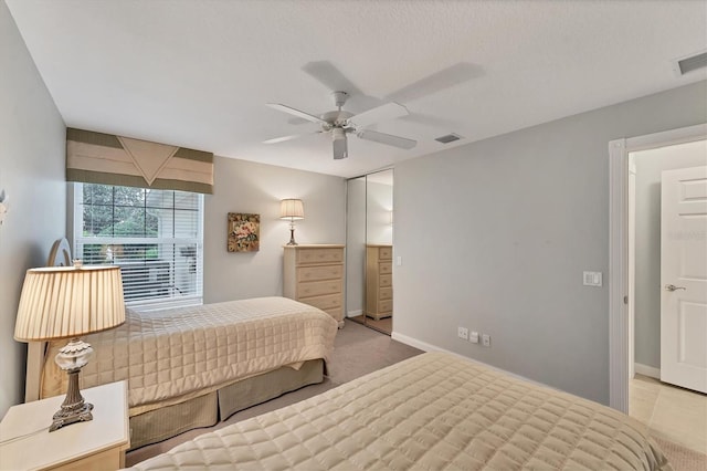 bedroom featuring a textured ceiling and ceiling fan