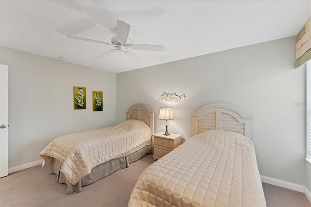 bedroom with ceiling fan and light carpet