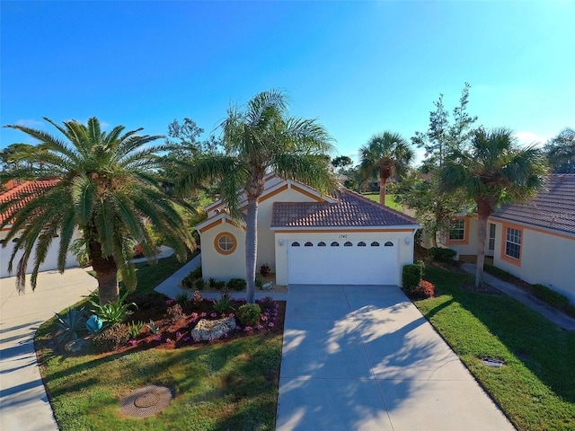 mediterranean / spanish-style house with a front lawn and a garage