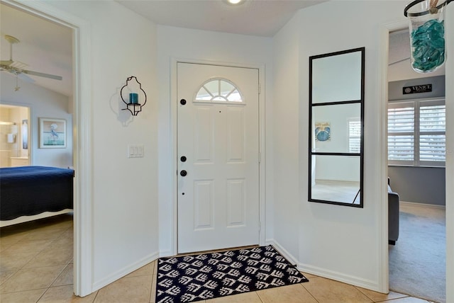 entrance foyer with ceiling fan and light tile patterned floors