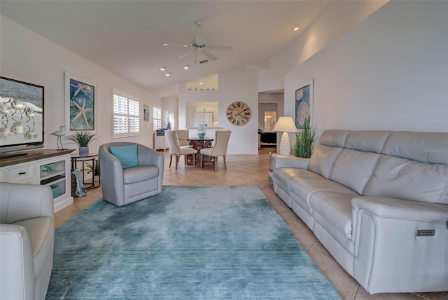 tiled living room featuring ceiling fan and vaulted ceiling