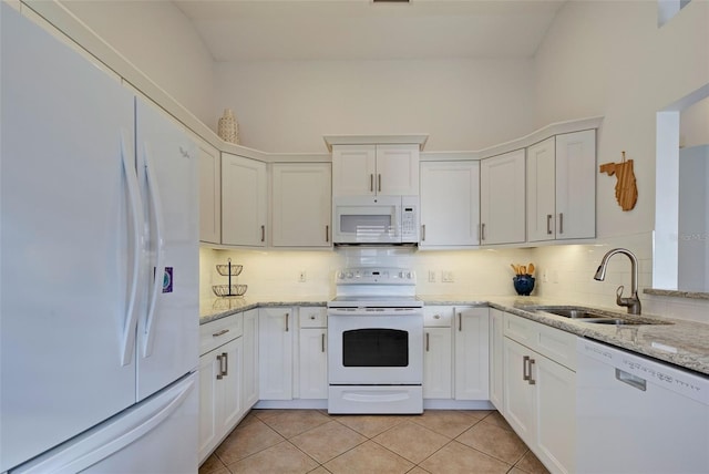 kitchen featuring sink, white appliances, white cabinetry, and light tile patterned flooring