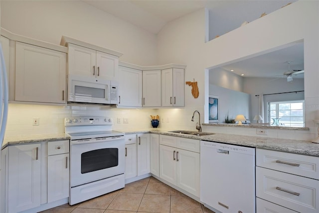 kitchen with white appliances, white cabinetry, tasteful backsplash, and sink