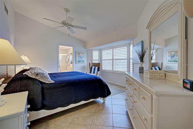 tiled bedroom with ceiling fan, ensuite bathroom, and lofted ceiling