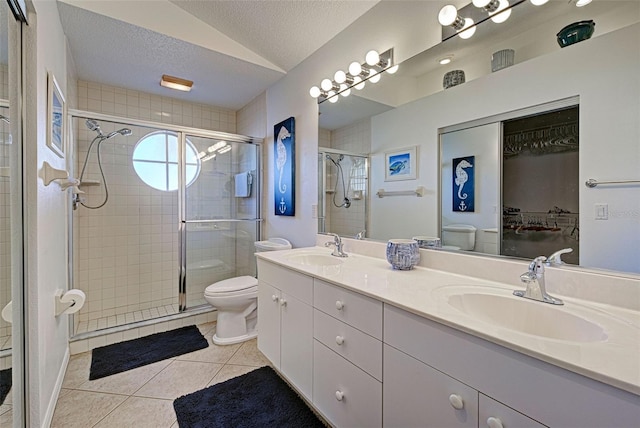 bathroom featuring toilet, a textured ceiling, vaulted ceiling, tile patterned flooring, and a shower with shower door