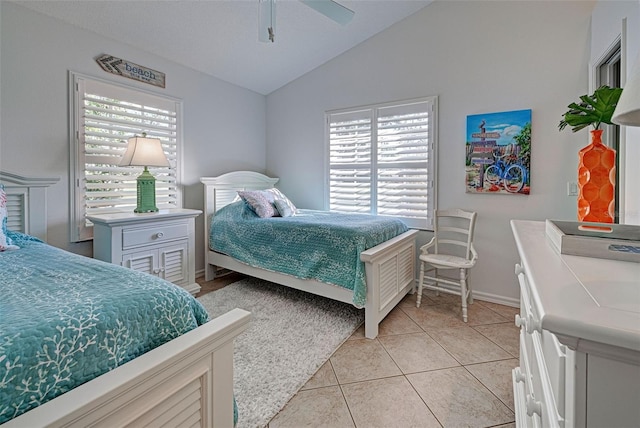 tiled bedroom with lofted ceiling and ceiling fan