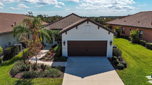 232 Carlino Dr, Nokomis, FL 34275 - mediterranean / spanish home featuring a tile roof, a front lawn, driveway, an attached garage, and stucco siding