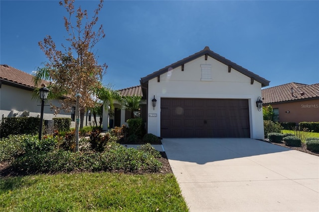 232 Carlino Dr, Nokomis, FL 34275 - mediterranean / spanish home featuring an attached garage, stucco siding, and concrete driveway