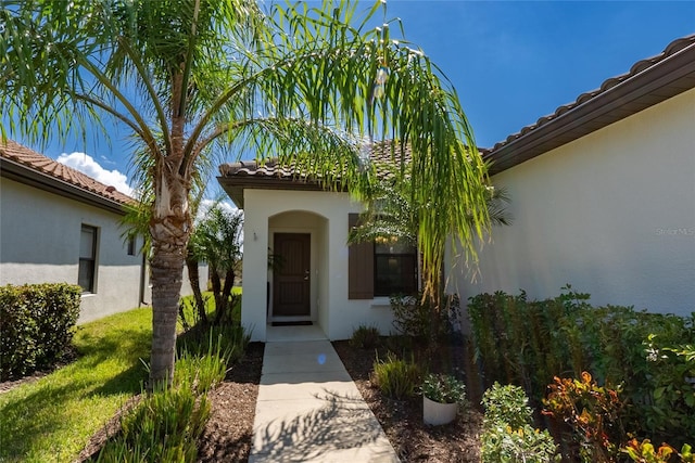 232 Carlino Dr, Nokomis, FL 34275 - property entrance with a tile roof and stucco siding