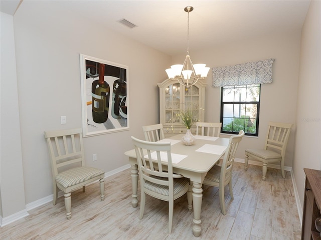 dining room featuring a chandelier and light hardwood / wood-style floors