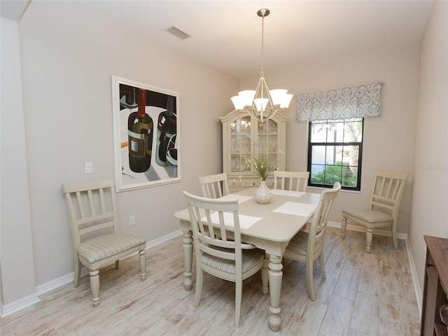 232 Carlino Dr, Nokomis, FL 34275 - dining room with baseboards, an inviting chandelier, visible vents, and light wood-type flooring
