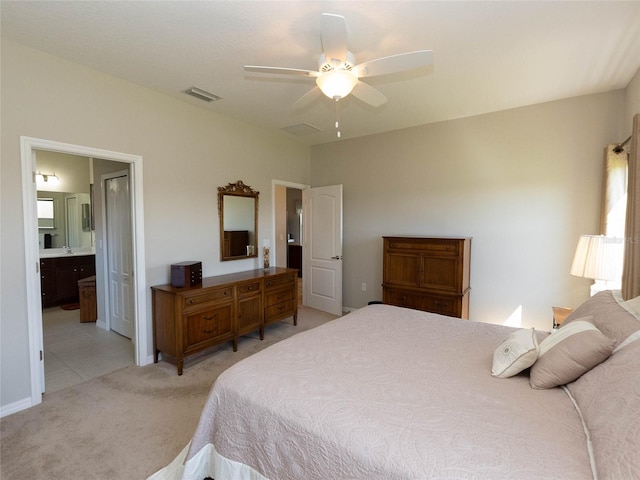 carpeted bedroom with connected bathroom and ceiling fan