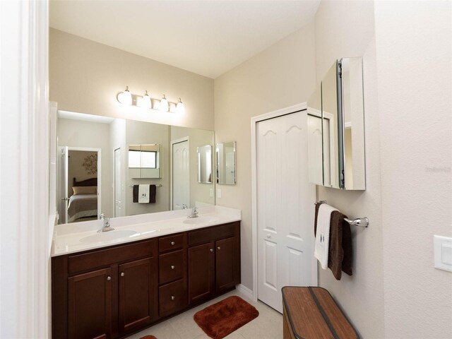 232 Carlino Dr, Nokomis, FL 34275 - ensuite bathroom featuring double vanity, tile patterned flooring, ensuite bathroom, and a sink