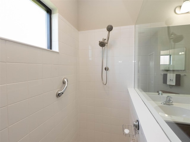 bathroom featuring vanity and tiled shower