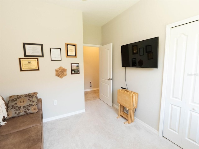 sitting room featuring light colored carpet