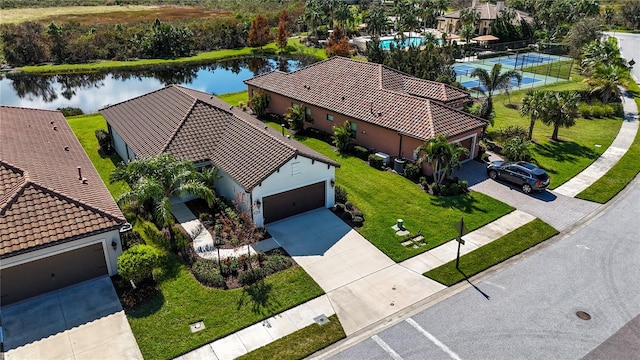 birds eye view of property with a water view