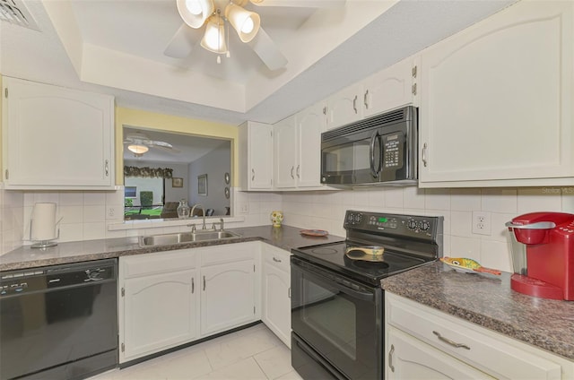 kitchen featuring white cabinetry, sink, a raised ceiling, backsplash, and black appliances