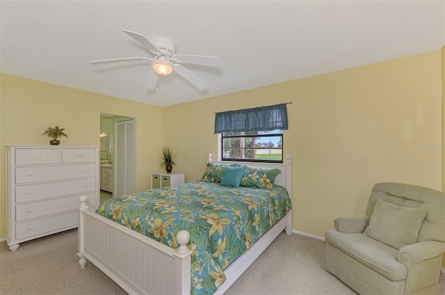 carpeted bedroom featuring connected bathroom and ceiling fan