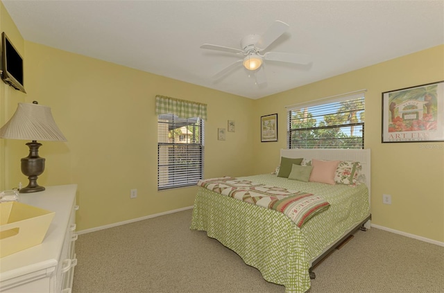 carpeted bedroom featuring ceiling fan and sink