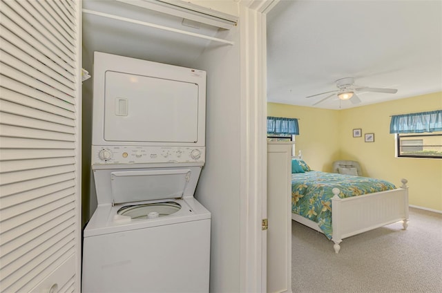 laundry area with carpet flooring, ceiling fan, and stacked washer and clothes dryer