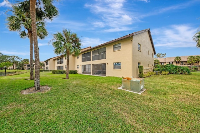 rear view of property with a lawn