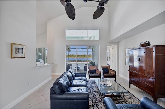 living room featuring a towering ceiling and light tile patterned flooring