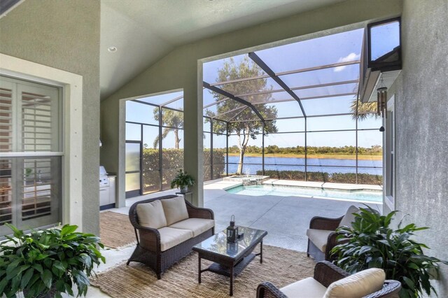 exterior space with a lanai, a water view, and an outdoor living space