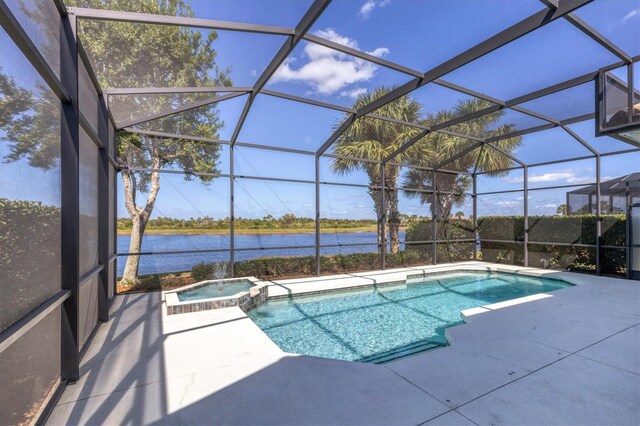 view of pool featuring a water view, an in ground hot tub, glass enclosure, and a patio area