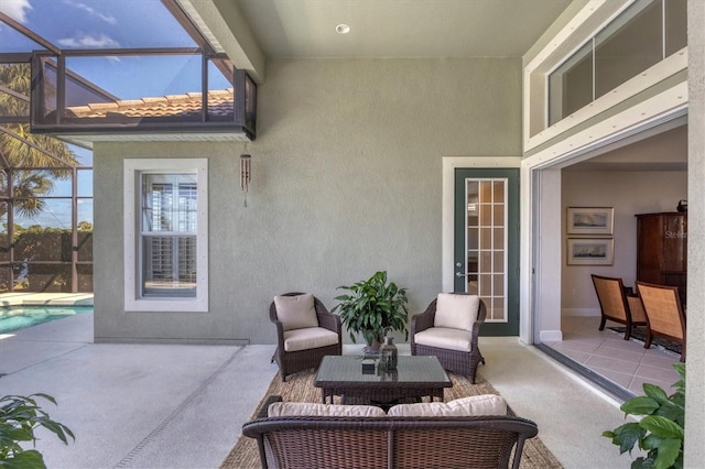 view of patio featuring glass enclosure