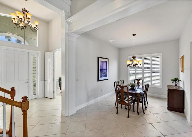 dining space featuring decorative columns, an inviting chandelier, and light tile patterned floors