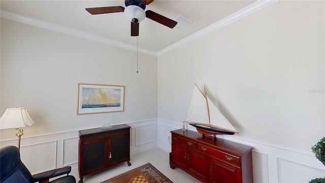 sitting room featuring crown molding and ceiling fan