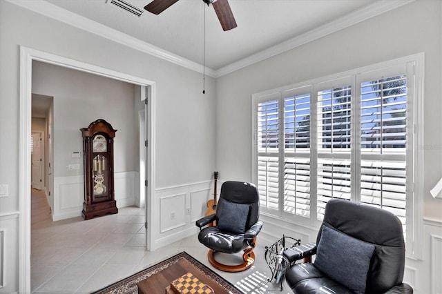 living area featuring ceiling fan, light tile patterned flooring, and crown molding