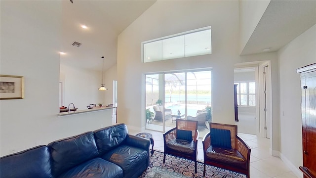 living room featuring high vaulted ceiling and light tile patterned floors