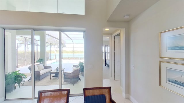 doorway featuring light tile patterned floors and a healthy amount of sunlight