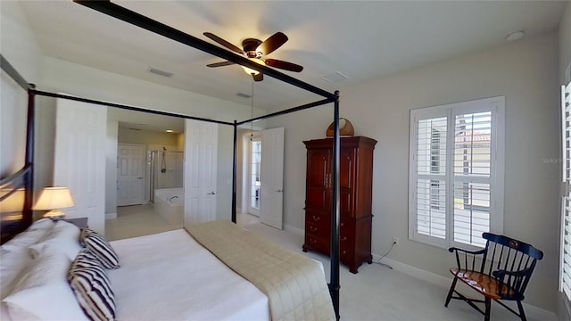 bedroom with light colored carpet, ensuite bathroom, and ceiling fan