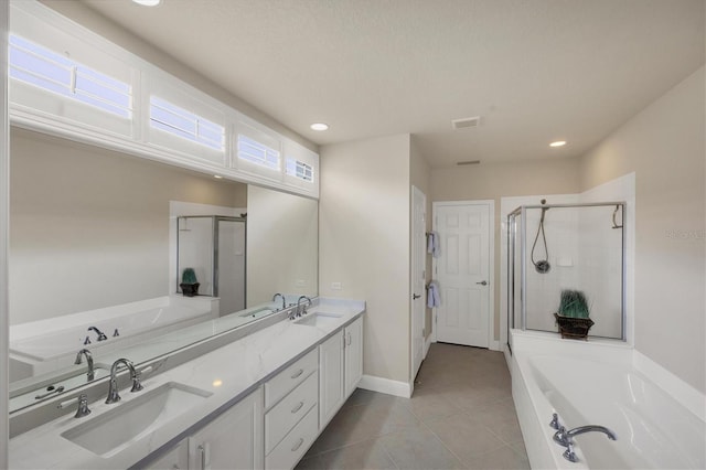 bathroom with tile patterned flooring, a healthy amount of sunlight, vanity, and independent shower and bath