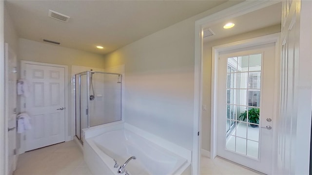 bathroom with tile patterned flooring and independent shower and bath